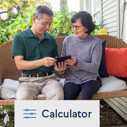 A couple using a life insurance calculator on a tablet