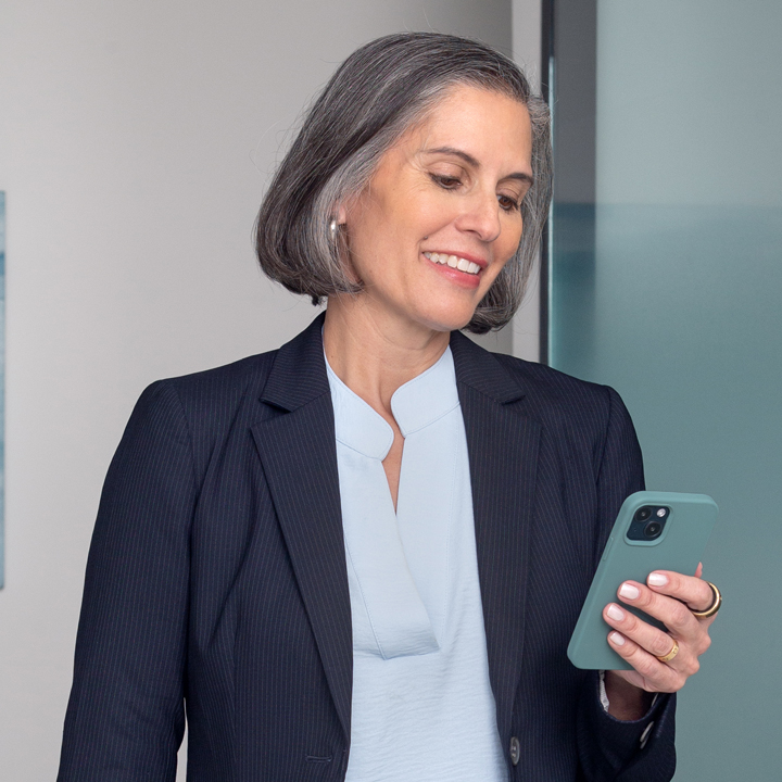 A woman looking at auto insurance rates on her phone