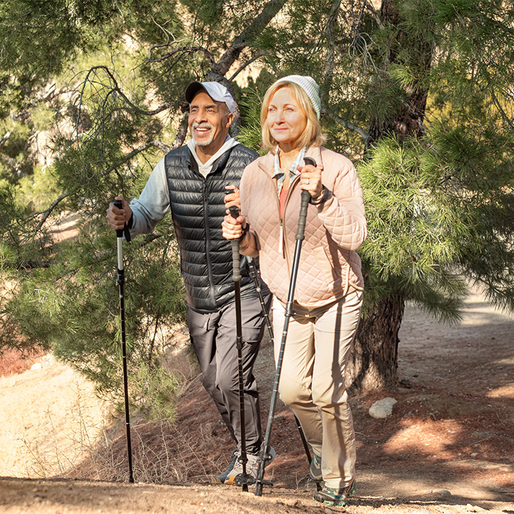 A man and woman discuss life insurance from TruStage on their hike
