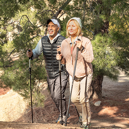 A man and woman discuss life insurance from TruStage on their hike