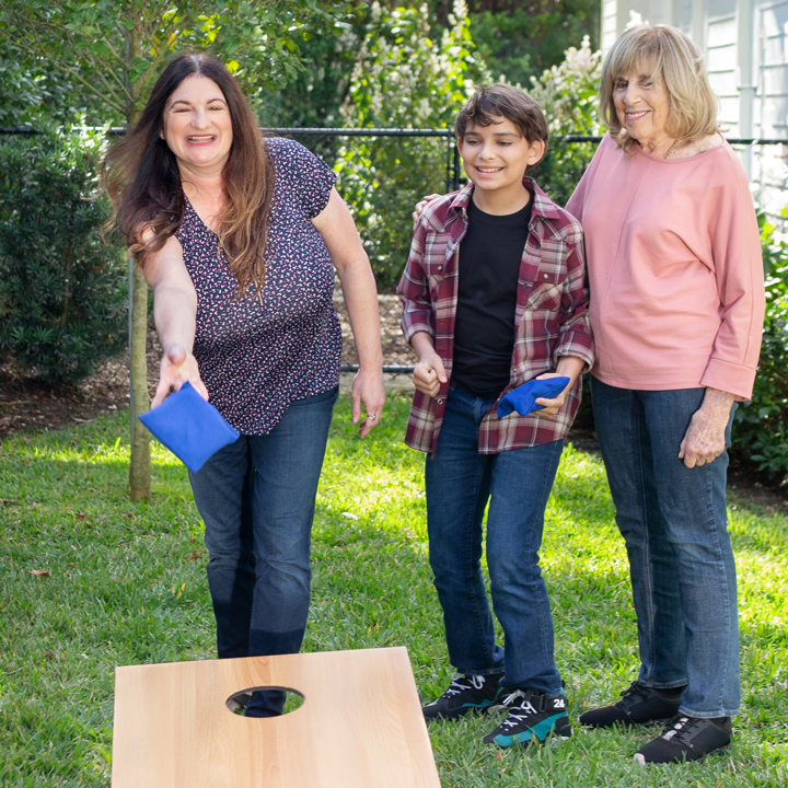 A family playing bag toss