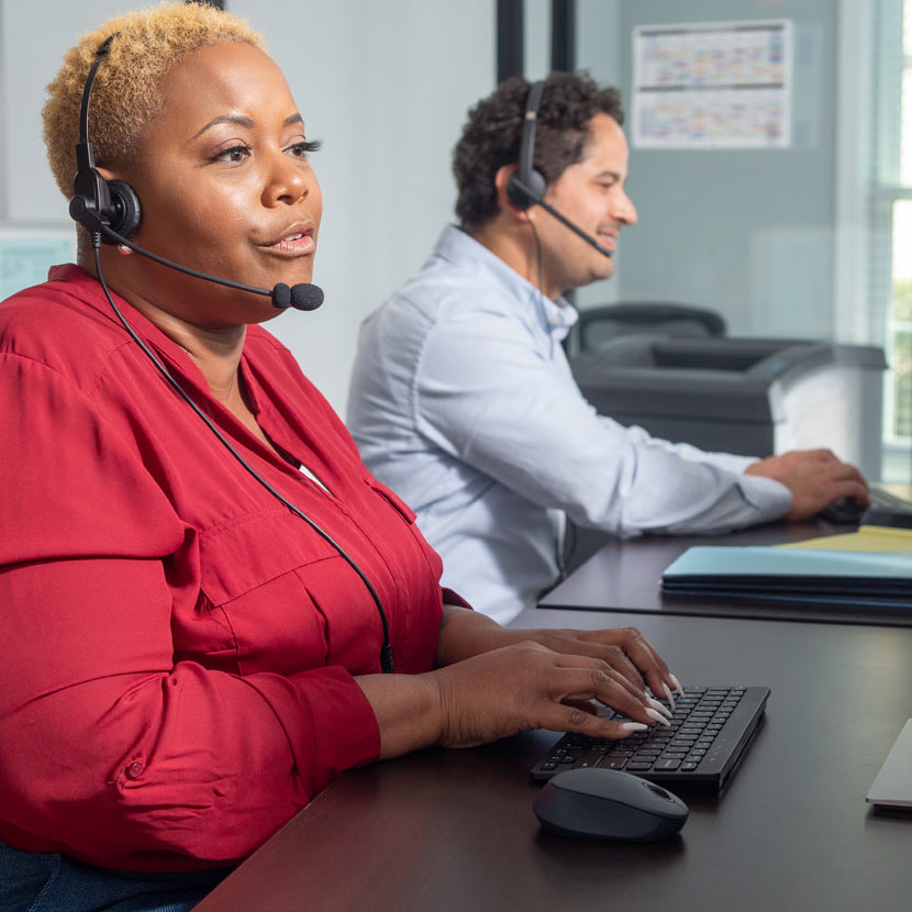A call center employee follows TruStage security tips while assisting a member by phone. 