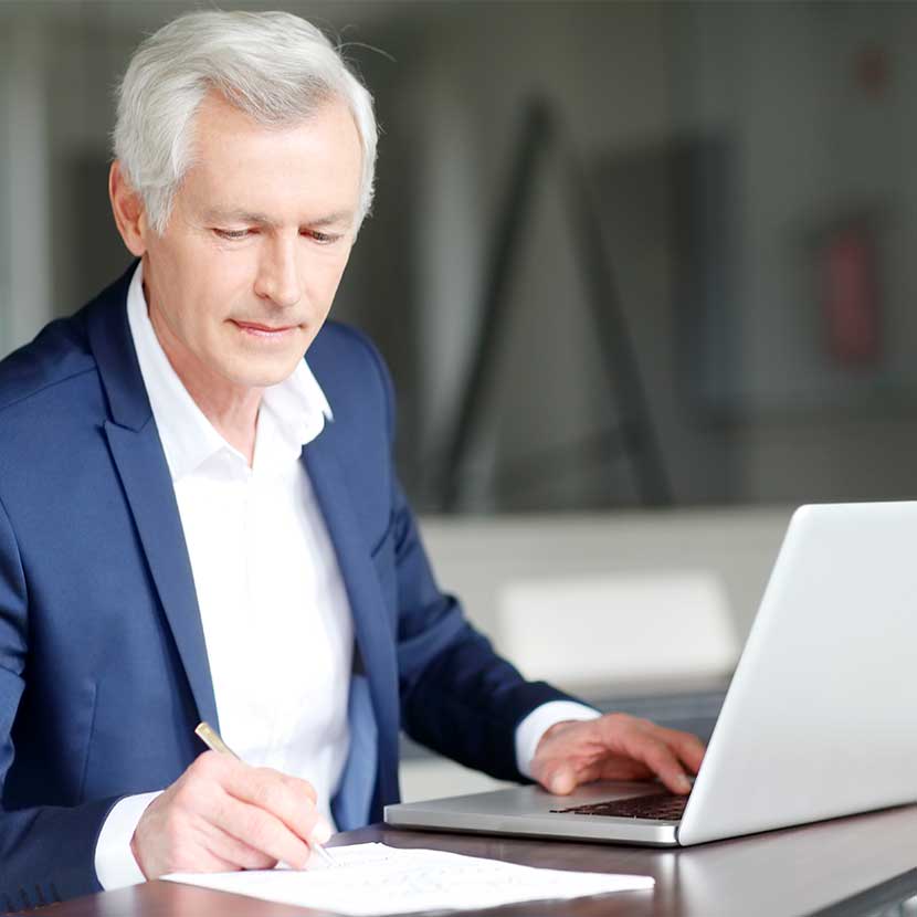 A financial professional reads TruStage™ annuities blog on his laptop to help grow his business.