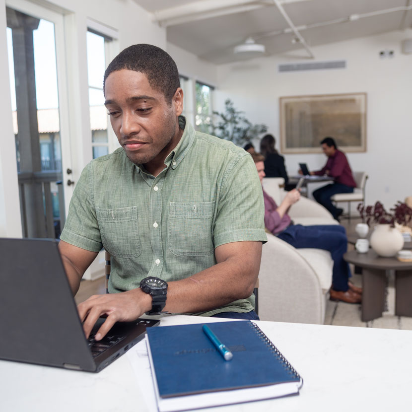 A man researches TruStage credit insurance on his laptop